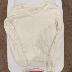 White/off white v-neck sweater.